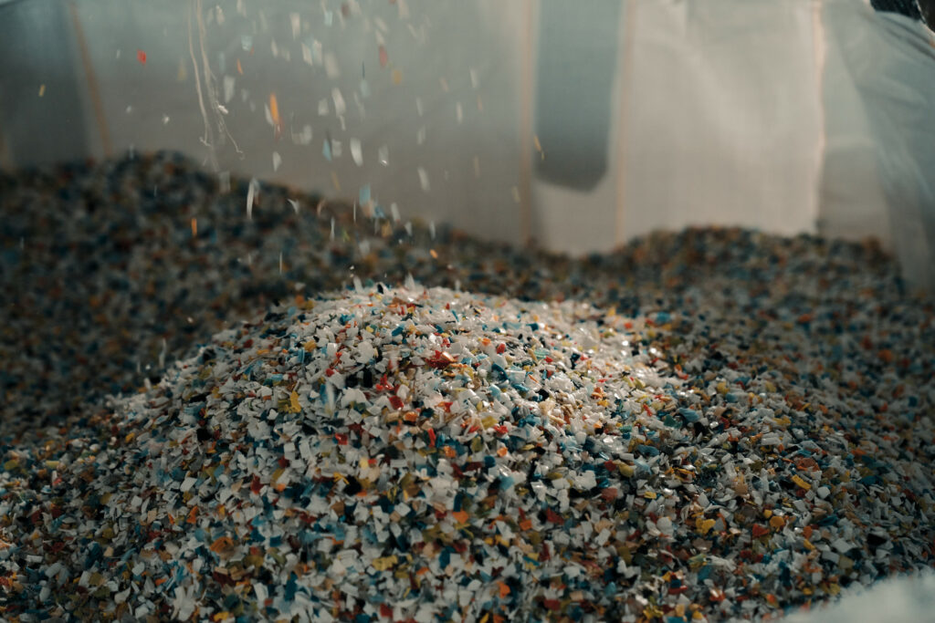 Shredding recycled PET bottles is an initial steps in the mechanical recycling process recycling plastic.  